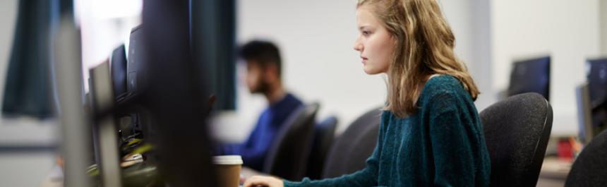 Girl using computer in computer room