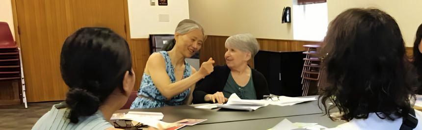 Three patrons practicing English conversation with their teacher. 