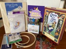 embroidery supplies and a book entitled Queen of the Sea