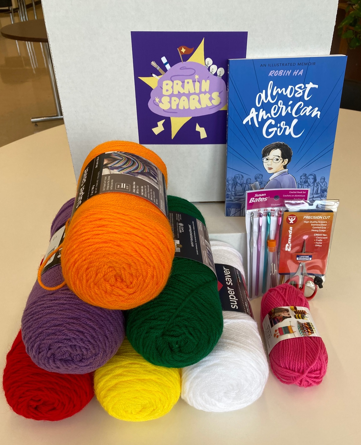 picture of stacks of yarn and the book Almost American Girl