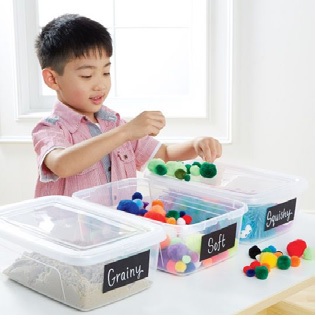 boy playing with sensory materials