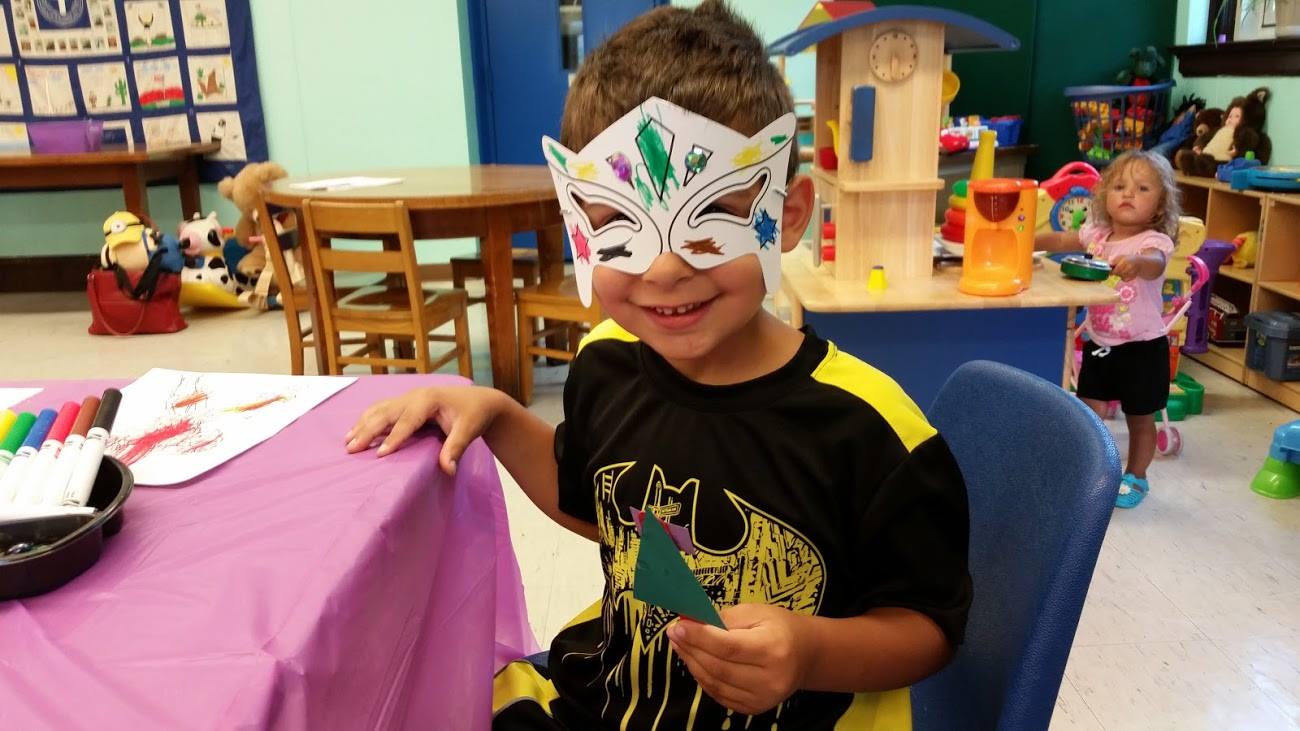 a boy wearing fancy mask