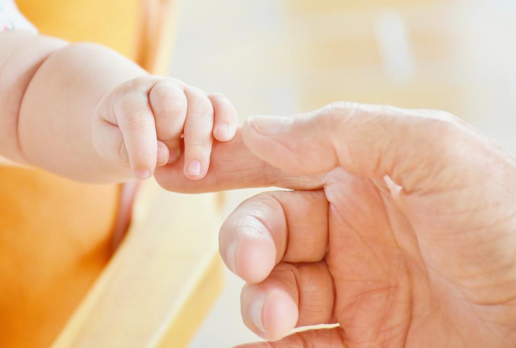 child hand and adult hand